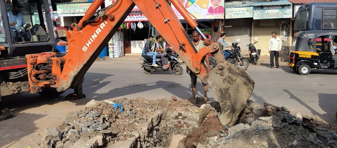 Excavator trenching for the new drainage line in a Kailash Nagar lane